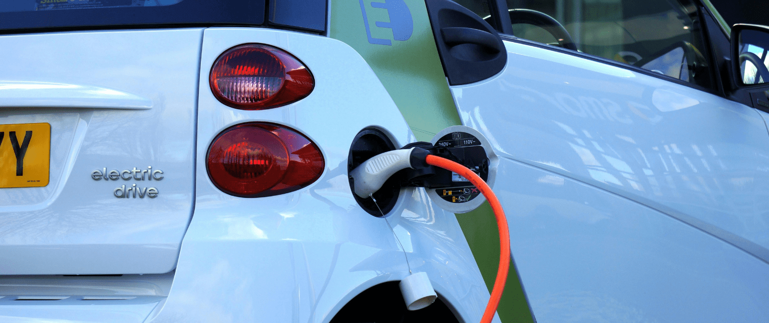 Electric vehicle charging. Depicted as an emission-free transport option.